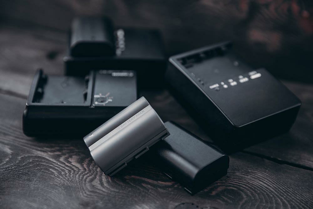 Vladivostok, Primorsky Krai / Russia - 11.29.2018: Three chargers and three batteries for the camera