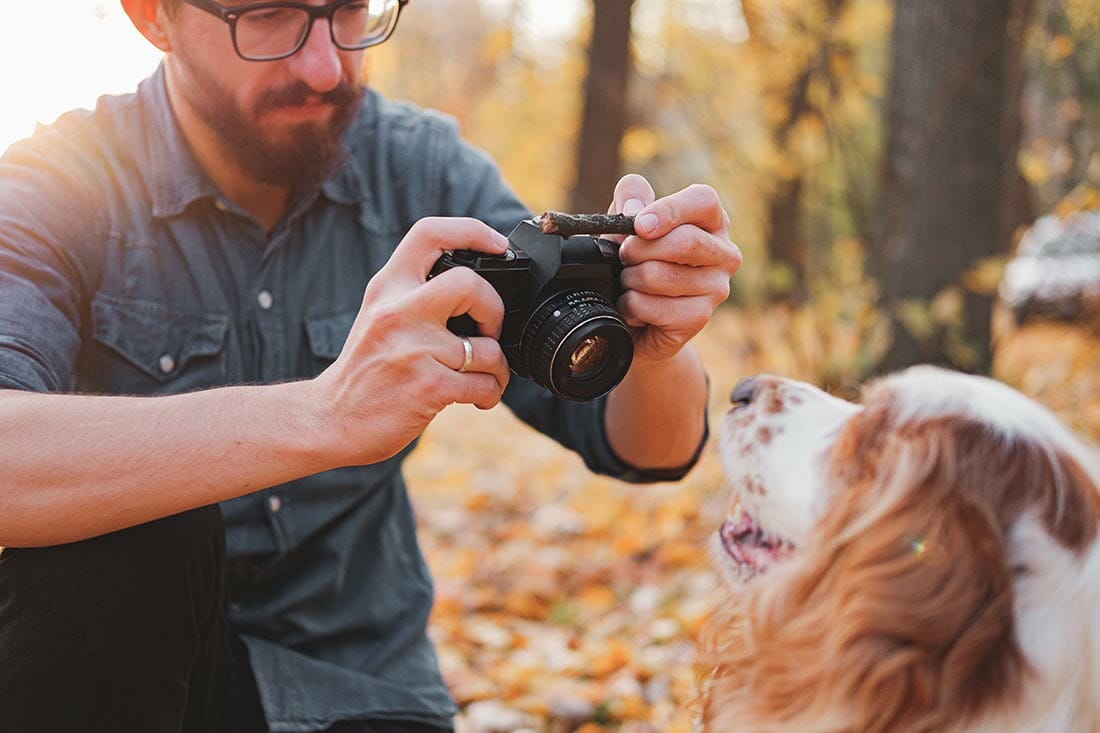 Man,Taking,A,Photo,Of,His,Dog,In,The,Park.