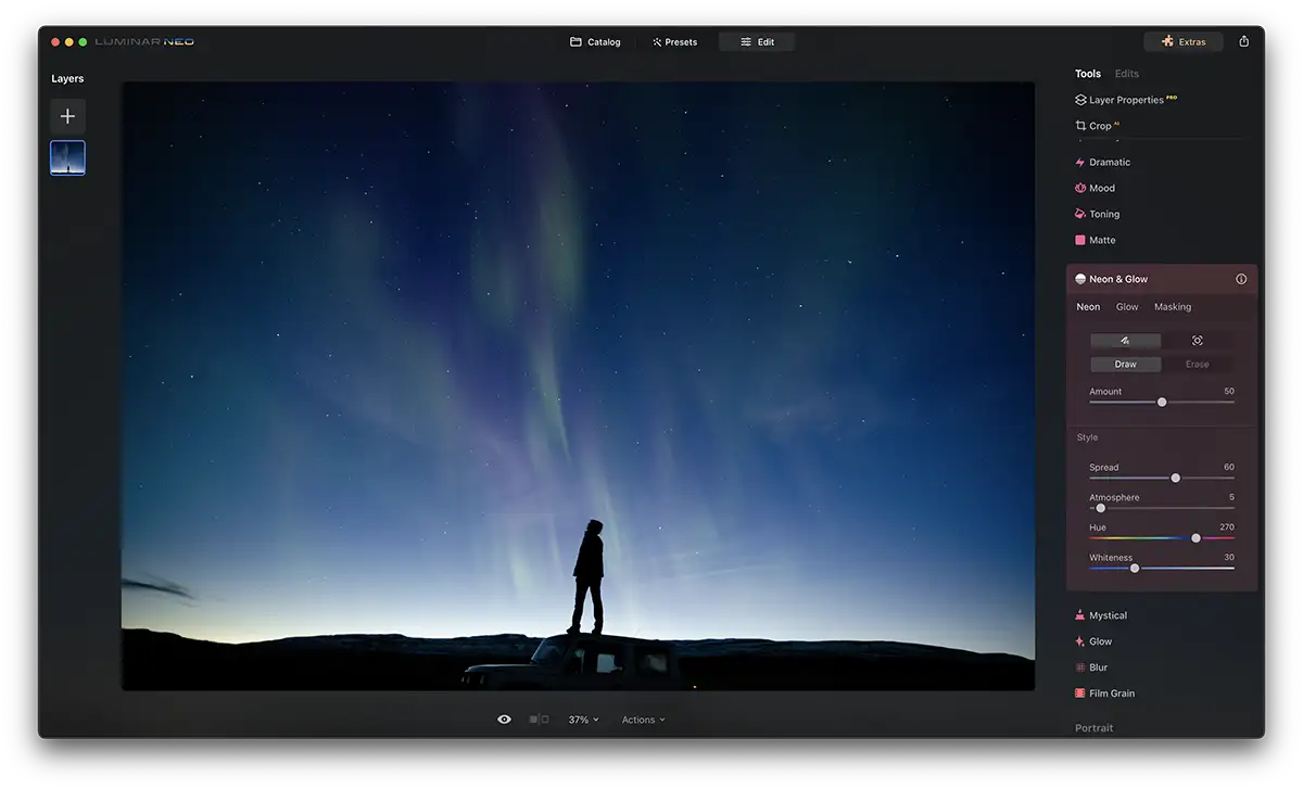 Screenshot of Luminar Neo Neon Glow Effect with a blue glowing bar above a person stood on a car roof at night time. Stars are in the sky.