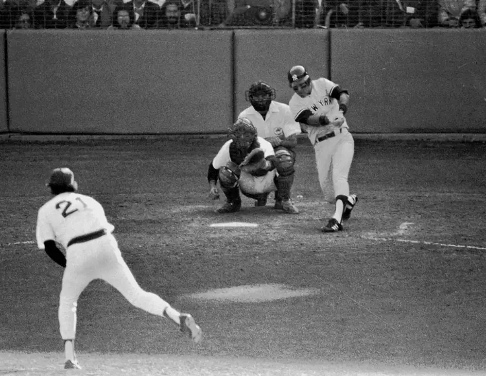 Black and white photo of a baseball player hitting the ball