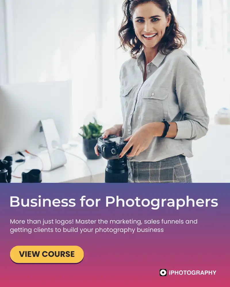 a smiling woman with a digital camera in her hand