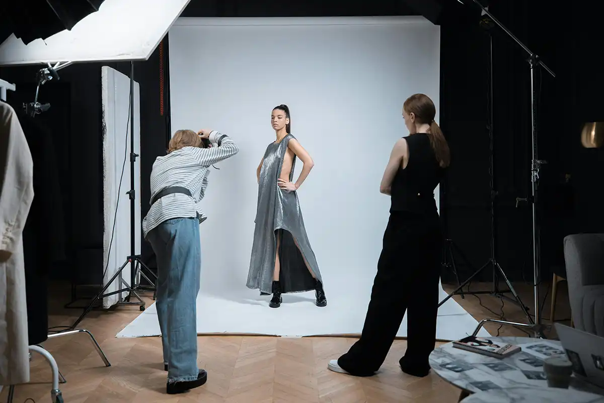 Fashion photographer and a model in a studio