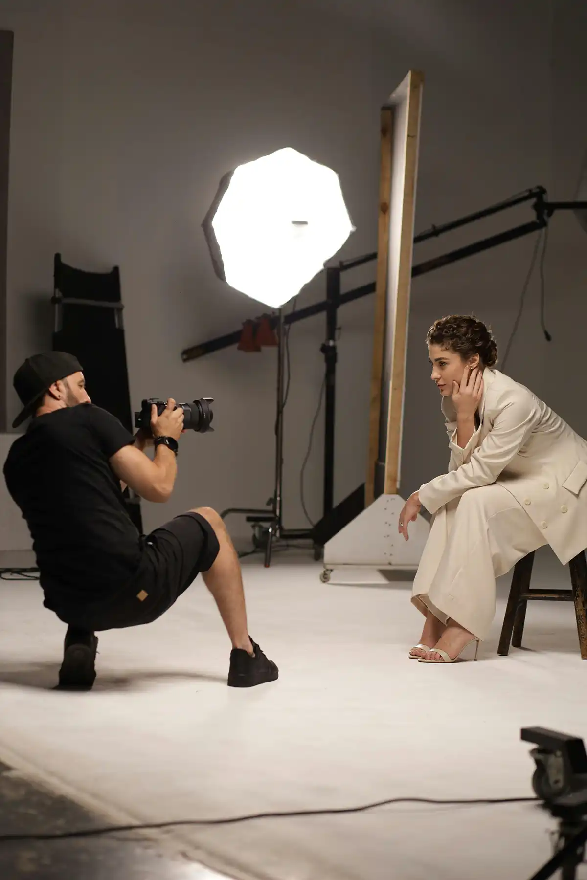 Fashion photographer and a model in a studio