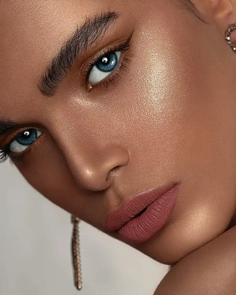 A close up of a beauty model's face with blue eyes and perfect skin