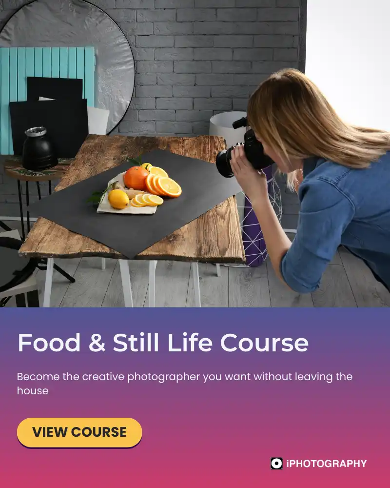 a woman taking a photo of fruit on a table