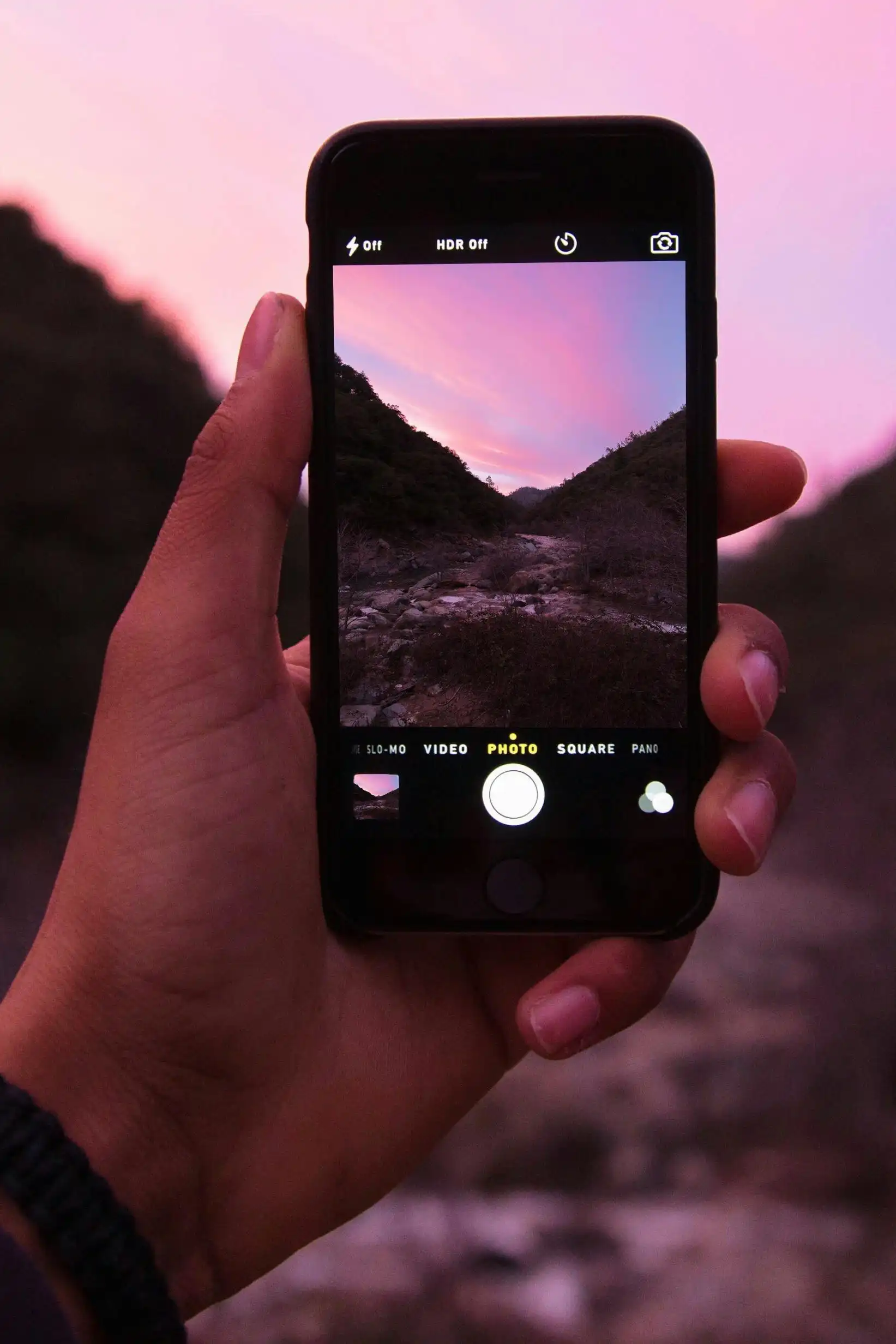 iPhone taking photo of a sunset sky