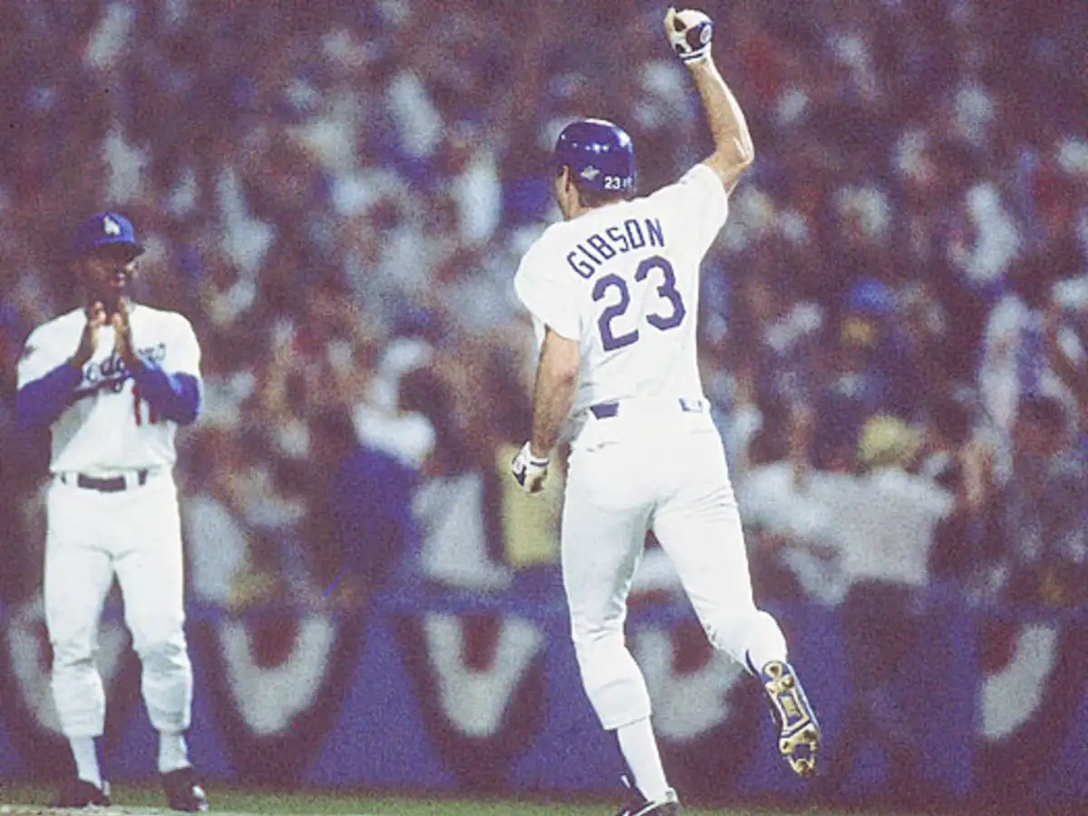 Baseball player wearing Gibson number 23 in a blue helmet celebrating