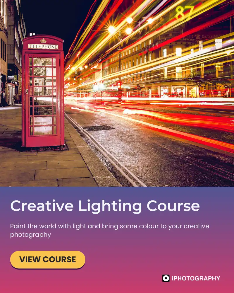 light trails passing at night a red london telephone box