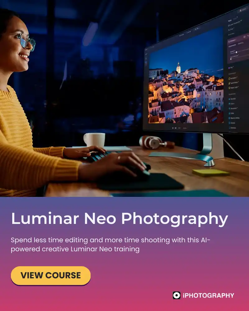 a woman sat at a computer in the dark editing photos