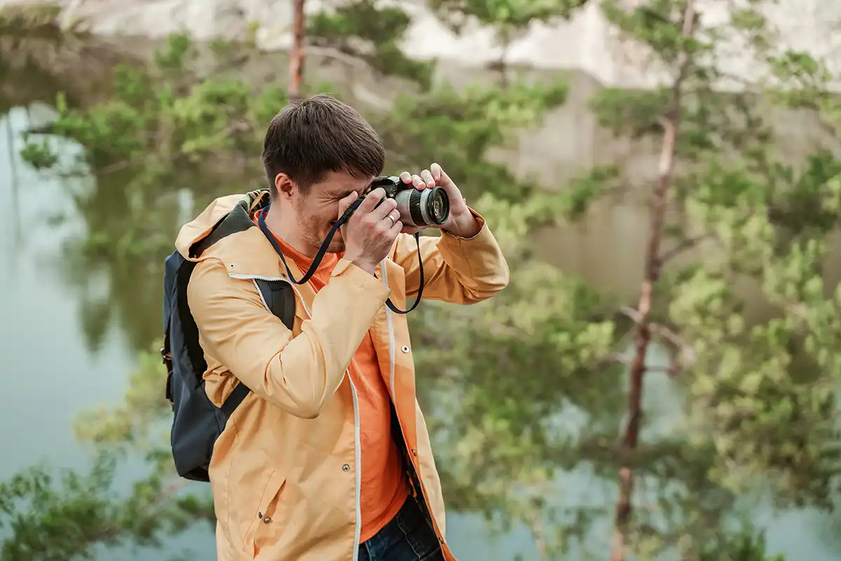 Man taking photo of trees