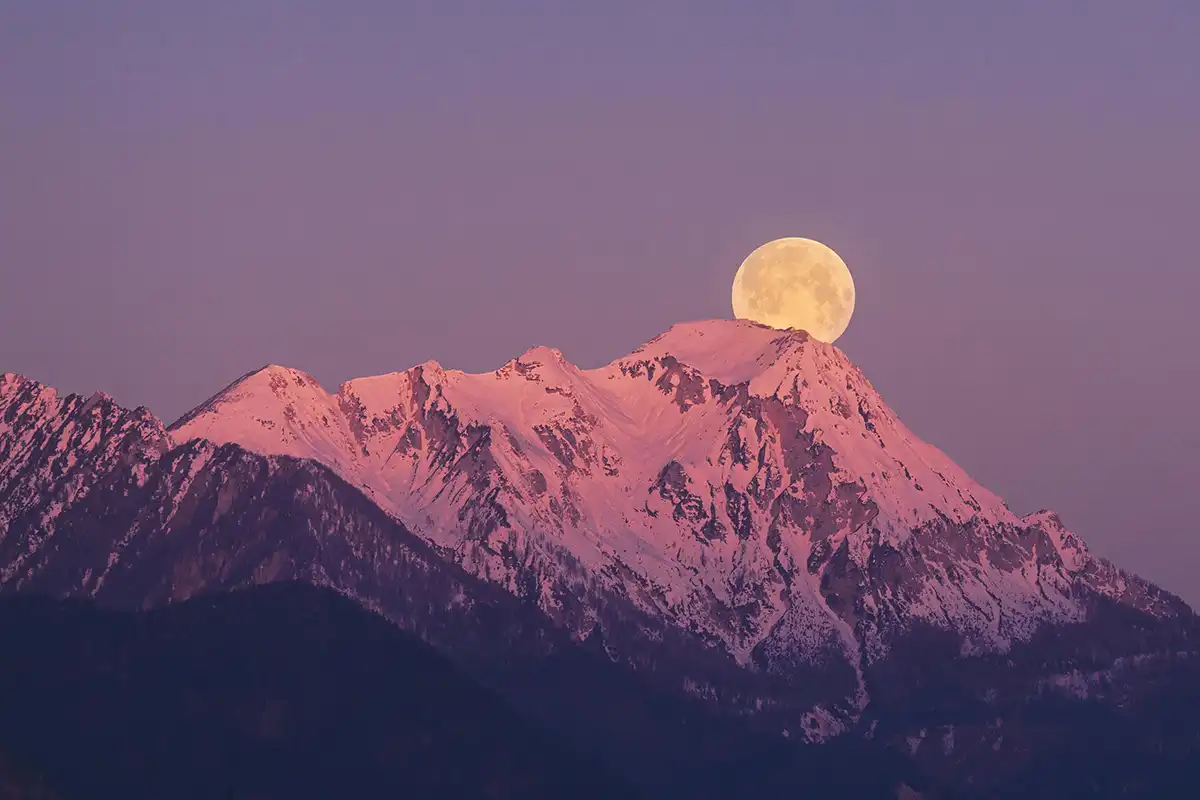 Supermoon over a mountain at dusk