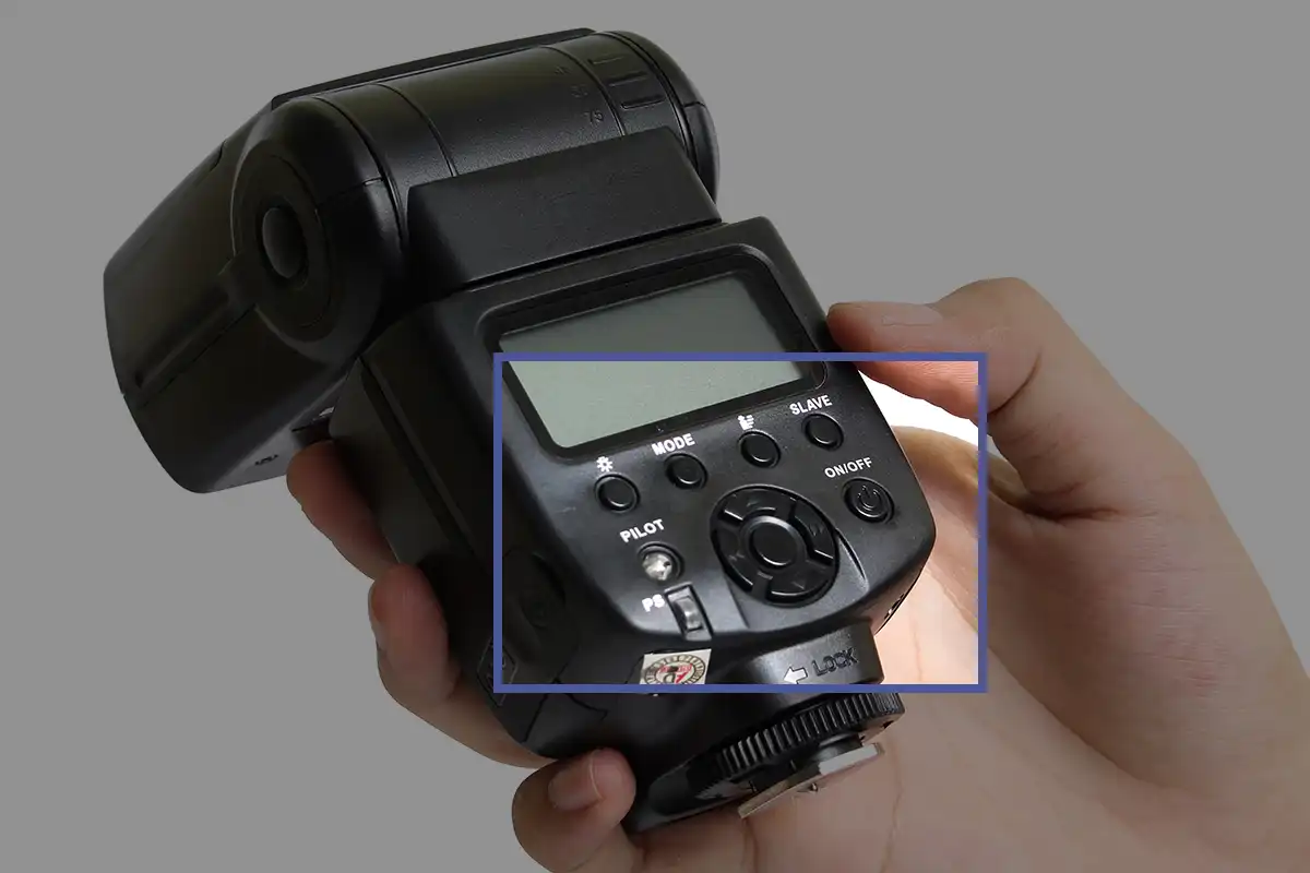 Close up of buttons on the back of a camera flash