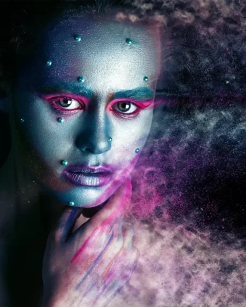 a sci-fi style photo of a female with blue skin breaking apart into dust