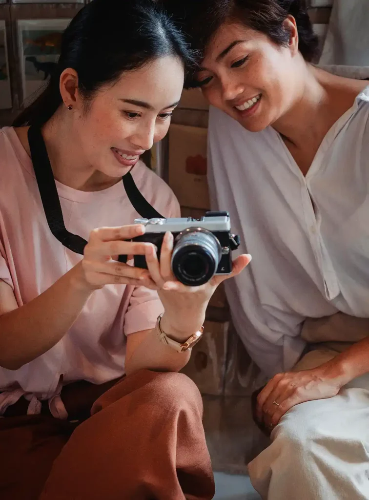 A close-up of a family reviewing a camera screen together.